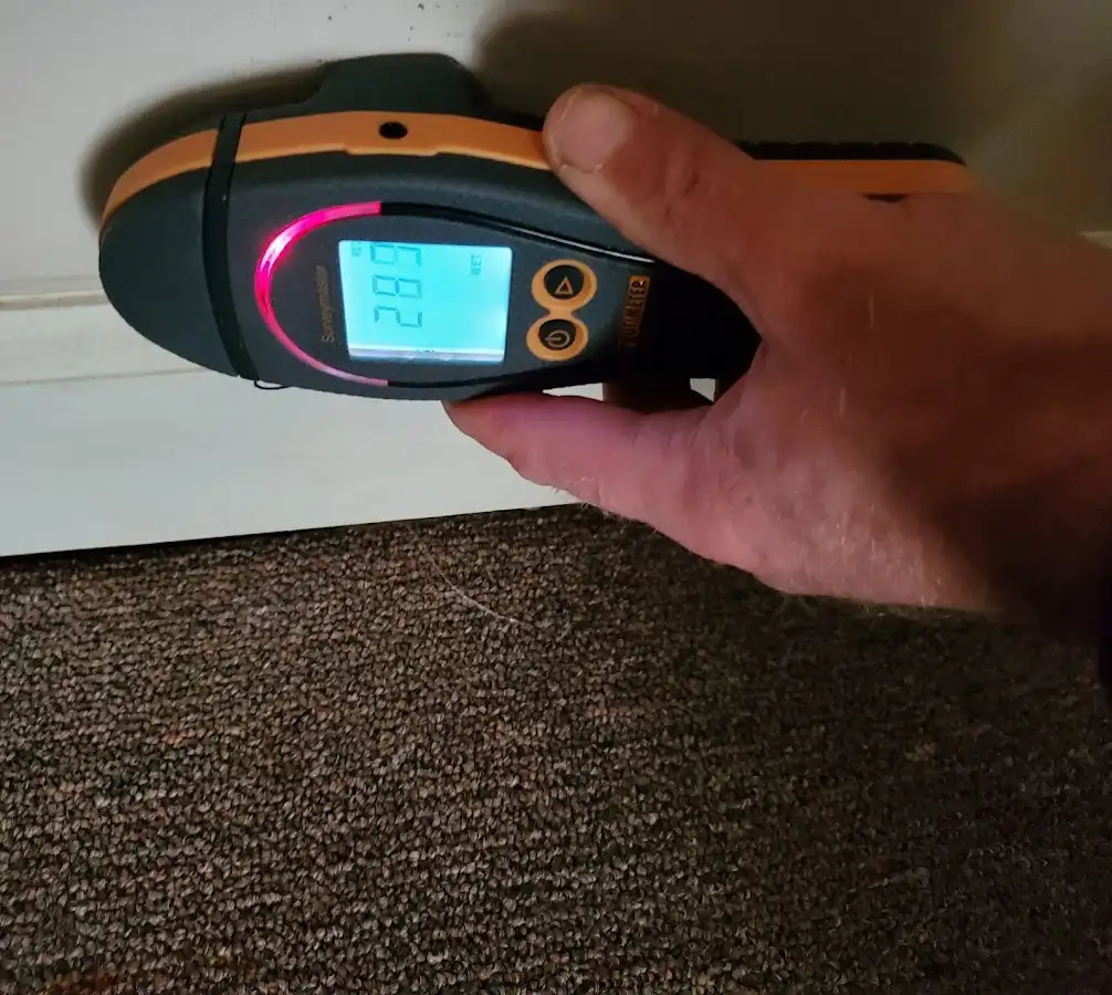 Moisture detection at baseboard during Storm Damage Restoration in Pavilion